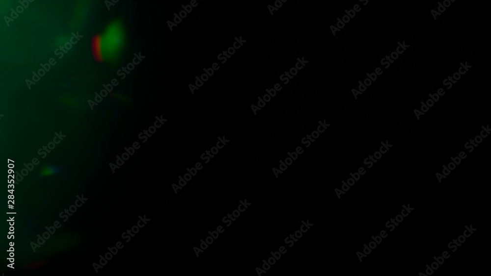 Real Lens Flare Shot in Studio over Black Background. Easy to add as Overlay or Screen Filter. Green and Gold light. Real Lens Flare Shot in Studio over Black Background. Easy to add as Overlay or Screen Filter. Green and Gold light.