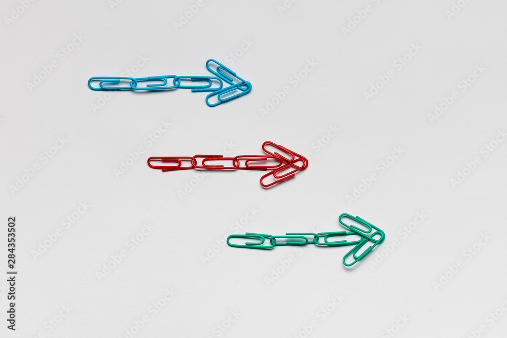 Many arrows pointing towards the right on white background, shot from above , closeup. Many arrows pointing towards the right on white background, shot from above , closeup.