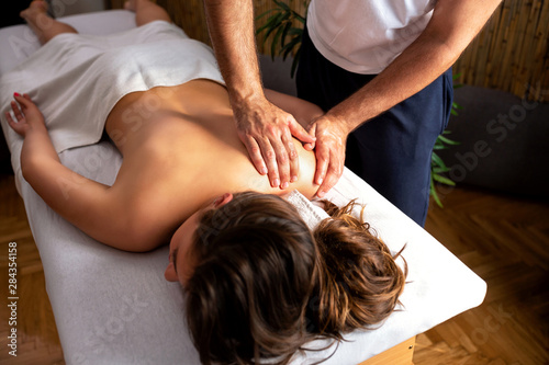 Attractive woman having a shoulder massage