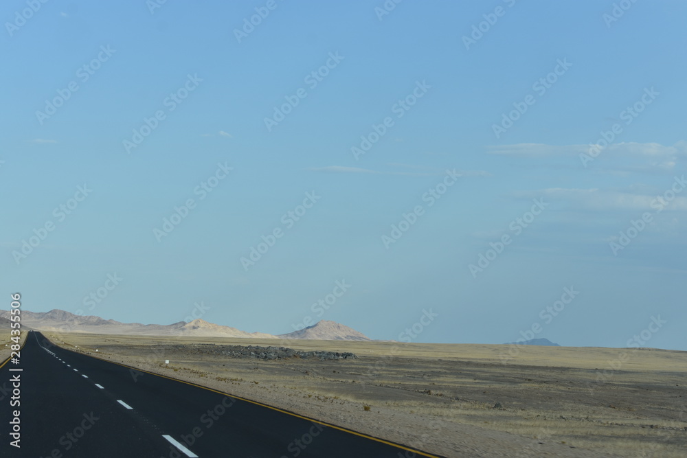 A road into the desert landscape and mountains