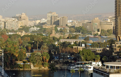 EGYPT, Cairo. Overview of a district of central Cairo, with its buildings, coconuts and a big mosque 