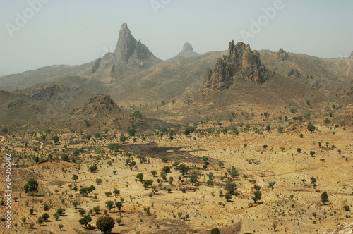 Cameroon, Rhumsiki. Rocks rising in the middle of an arid landscape photo