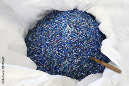 Flakes from recycled plastic bottles in a bag. photo