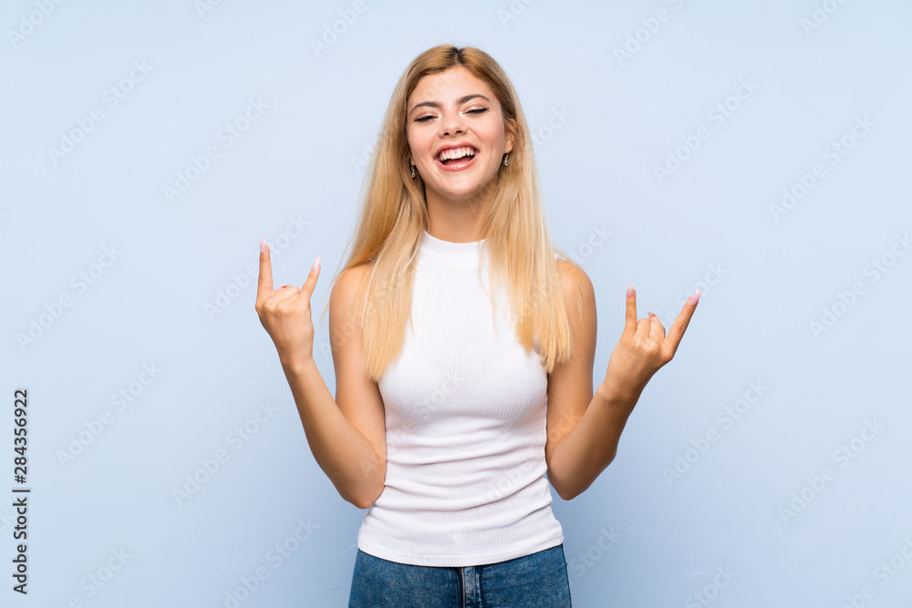 Teenager girl over isolated blue background covering eyes by hands. Do not want to see something