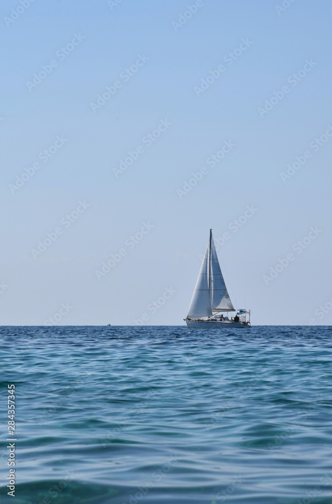 Sailing yacht at sea on a sunny day.