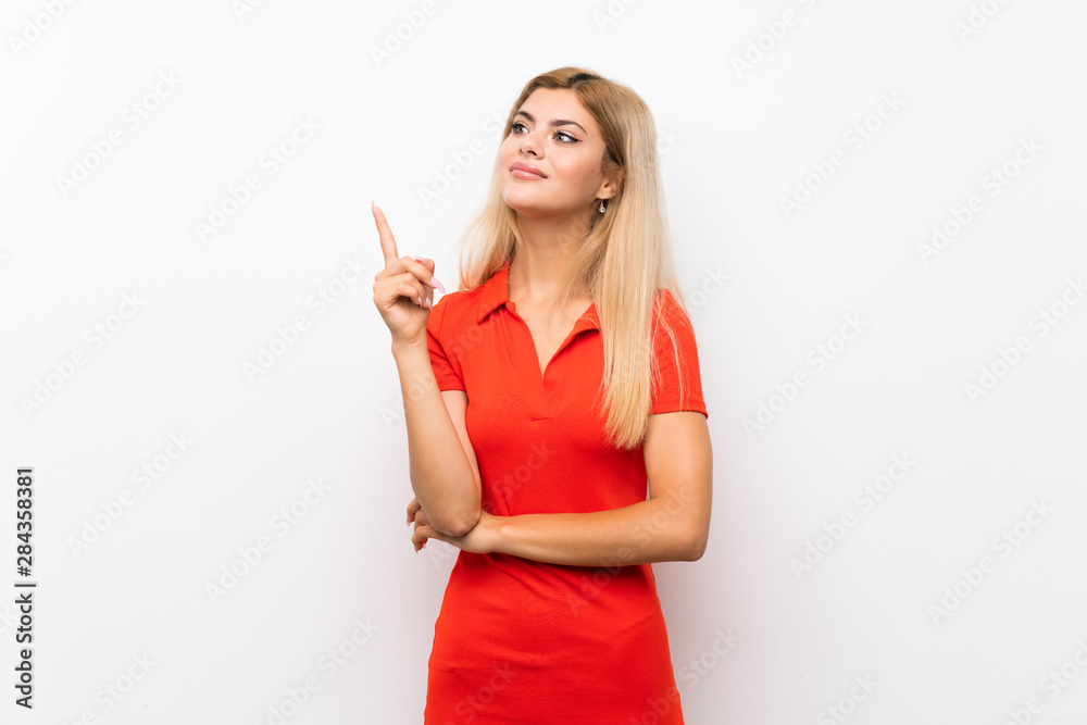 Teenager girl over isolated white background showing and lifting a finger in sign of the best Teenager girl over isolated white background showing and lifting a finger in sign of the best