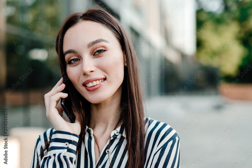 beautiful woman talking on the phone and smiling outdoors beautiful woman talking on the phone and smiling outdoors