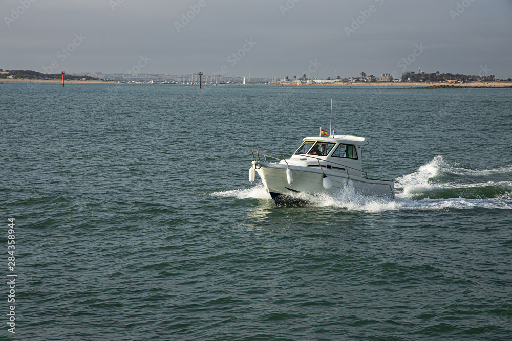 Fototapeta premium small motor boat sailing the sea