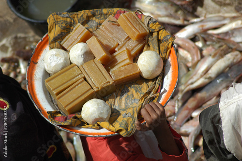 MALI, Mopti. Rooftop view of plates of local products carried by a woman  photo