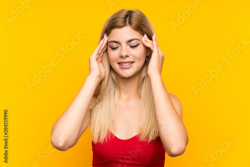 Teenager girl over isolated yellow background unhappy and frustrated with something. Negative facial expression