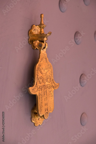 Morocco, Marrakech. A traditional door knocker, the hand of Fatima is said to bring good luck.