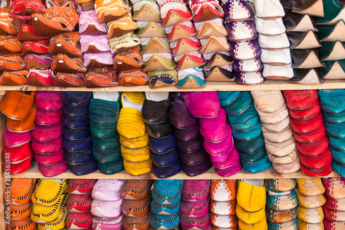 Morocco, Fes. Stacks of traditional shoes form a colorful pattern in this shop in the medina.