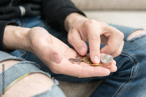 A poor male with a coins, poverty concept, Belarusian rubles, man's hands, close up