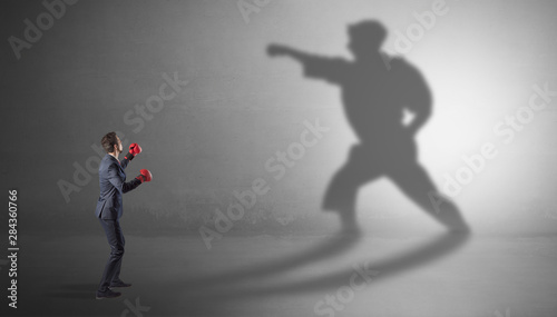Businessman fighting with his strong karate man shadow © ra2 studio