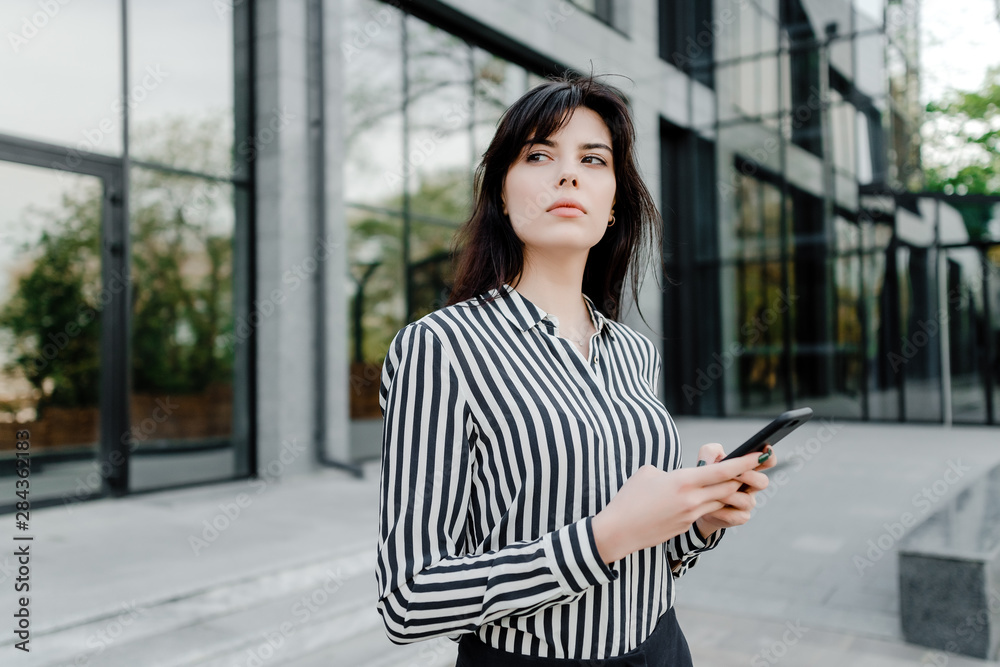 concentrated woman thinking with phone in hands concentrated woman thinking with phone in hands