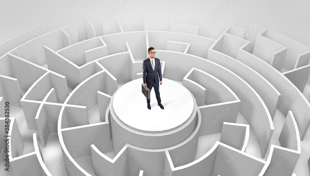 Businessman standing on the top a maze and looking through Businessman standing on the top a maze and looking through