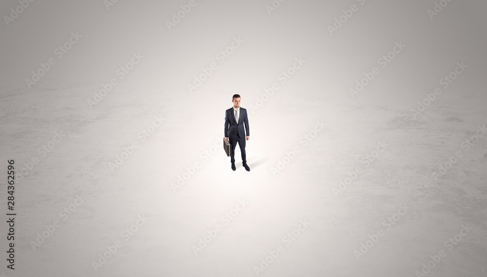 Young businessman standing alone in the middle of an empty space