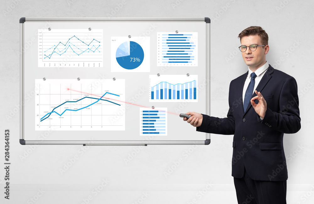 Handsome businessman presenting report on white board with laser pointer Handsome businessman presenting report on white board with laser pointer