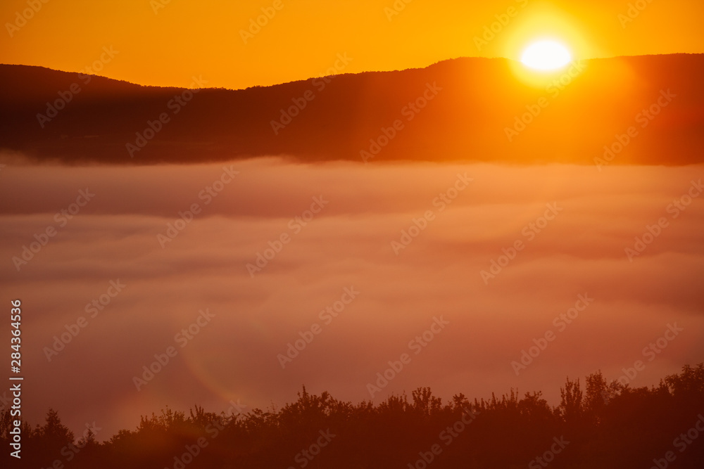 Early morning sunrise of a fog enshrouded valley, Stowe, Vermont, USA