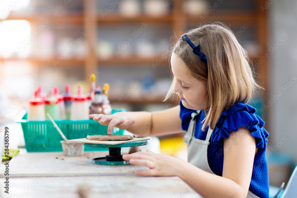 Child at pottery wheel. Kids arts and crafts class Child at pottery wheel. Kids arts and crafts class