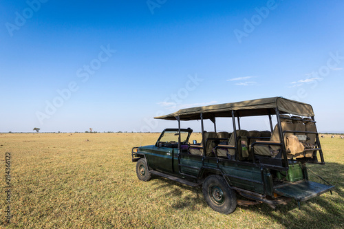 4x4 vehicle on the open plain of the Serengeti National Park, Tanzania © James White/Danita Delimont