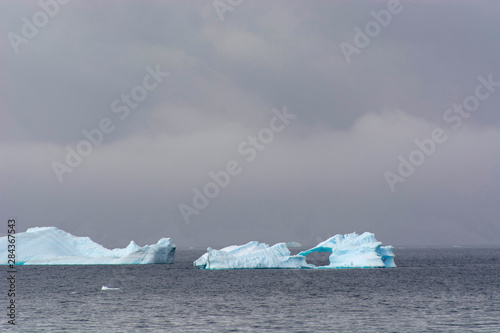 Antarctica. Gerlache Strait. Icebergs and stormy skies. photo