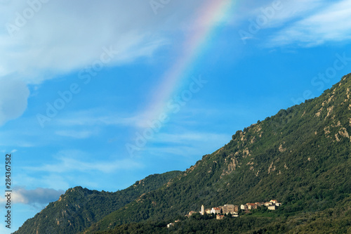 Rainbow on Santa Maria Poggio village in Corsica mountain