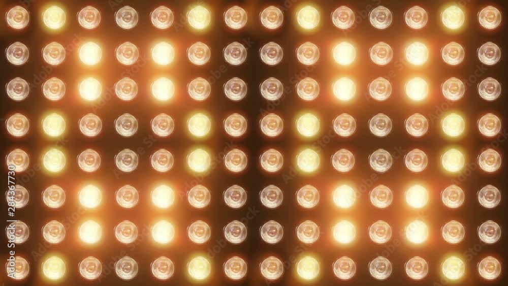 Wall of flashing lights and bright spotlights. Looped animations with glow and lens effects. Ideal background for video and music videos, for vibrant dynamic designs of composition from light