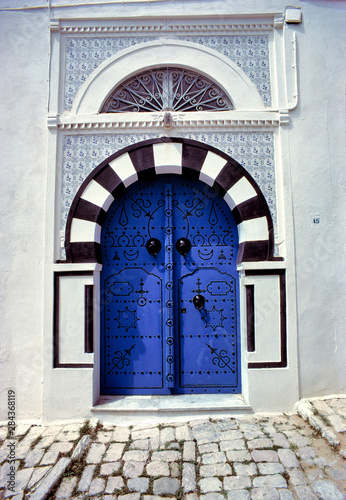 Striking tiles decorate the arches of this sapphire blue door in Sidi Bou Said  Tunisia.