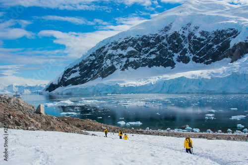 Antarctica. Neko Harbor. Hikers heading towards the penguin colony from the mountain.