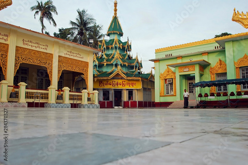 Myanmar, Mandalay, Inner yard of a buddhist palace with burmese writings on a panel