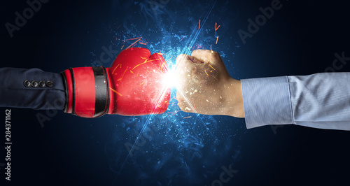 Two hands fighting with light, glow, spark and smoke concept © ra2 studio