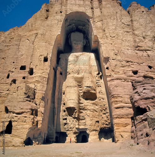 Afghanistan, Bamian Valley. A person stands at the base of the Great Buddha in the Bamian Valley, a World Heritage Site, in Afghanistan.