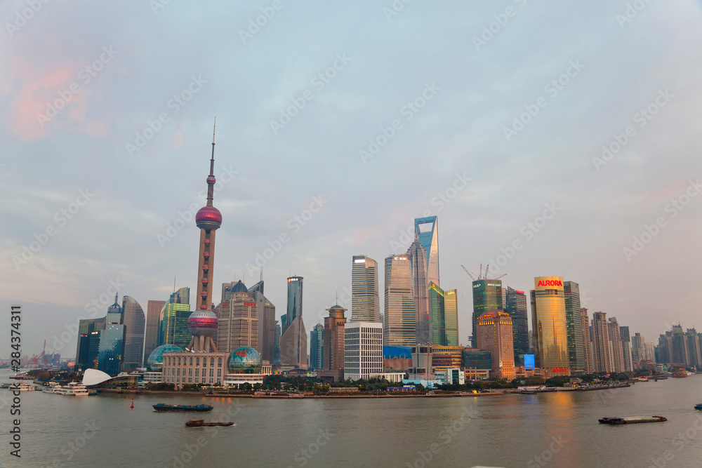 Barges and Pudong skyline, sunset, Shanghai, China