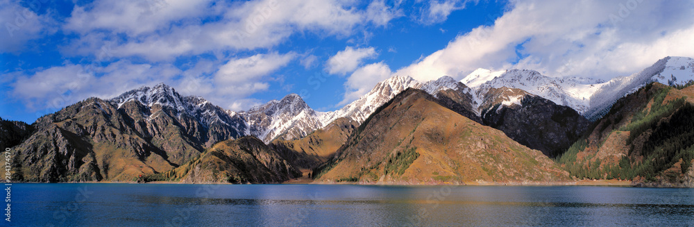 China, Xinjiang, Heavenly Lake. The snow-dappled peaks of Tien Shan Range surround Heavenly Lake, in Xinjiang, China.