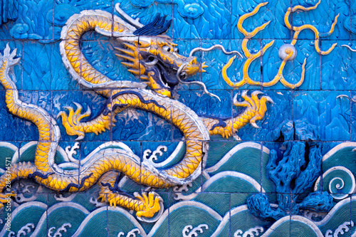 Asia, China, Beijing. Stylized dragons nearly jump from this tiled wall, in the Forbidden City, a World Heritage Site, Beijing, China.