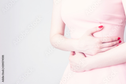 Wallpaper Mural Girl suffering stomach ache, clutching his stomach from acute pain, female hands, close up Torontodigital.ca
