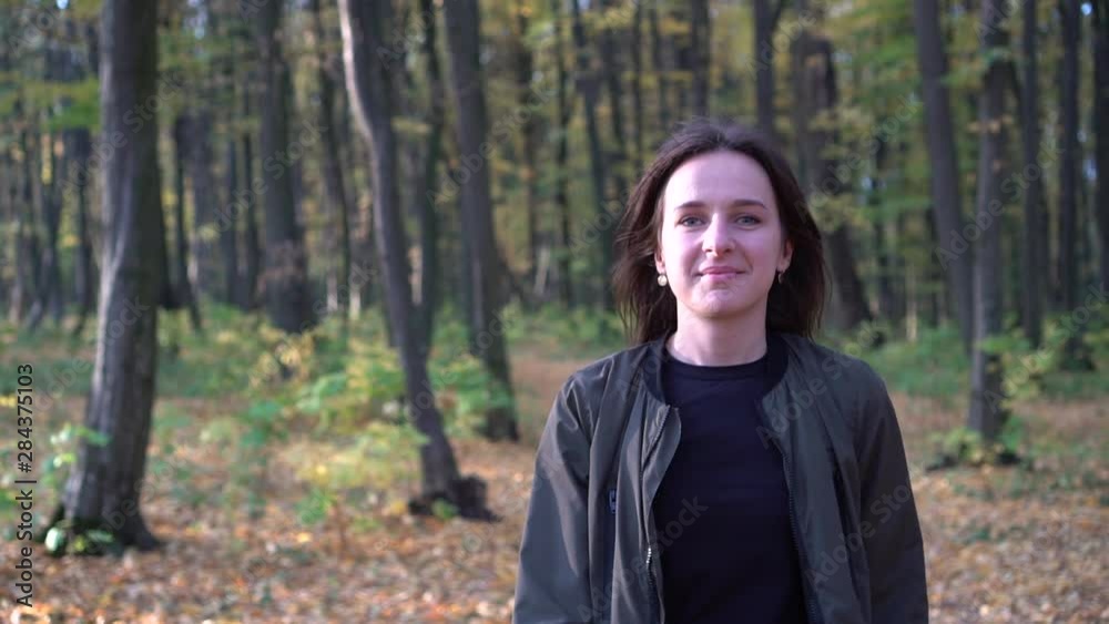 Portrait of a beautiful girl. Woman walking in autumn park. Steady back shot. Slow motion Portrait of a beautiful girl. Woman walking in autumn park. Steady back shot. Slow motion