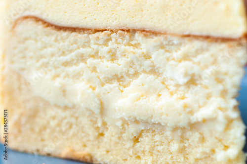 Photography Close up vanilla cream cake texture of cream layers on blue plate