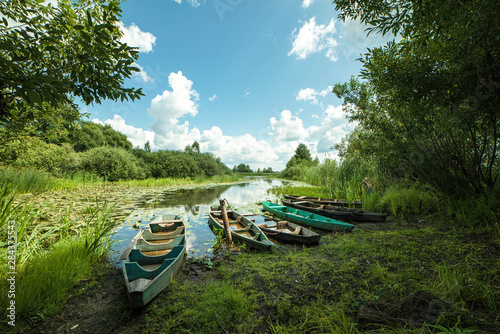 Fototapeta Naklejka Na Ścianę i Meble -  Beautiful scenery of wooden fishing boat on the river. Fishery boat on the river. Old wooden boat.