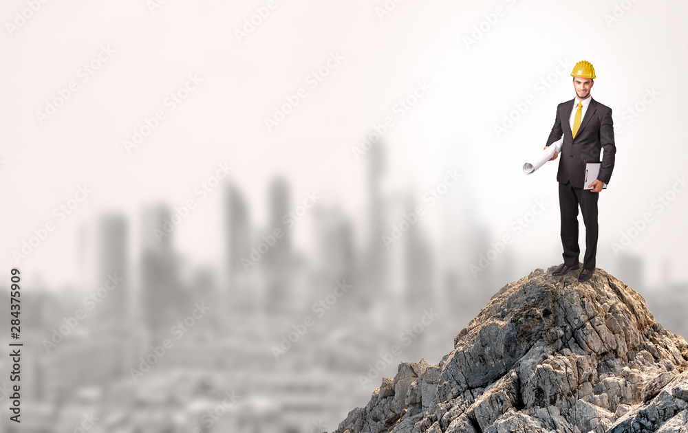 Young business person looking to the city from distance Young business person looking to the city from distance