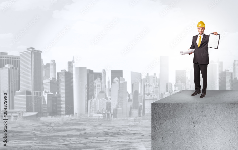 Young investor looking to the city from distance and thinking about investment Young investor looking to the city from distance and thinking about investment