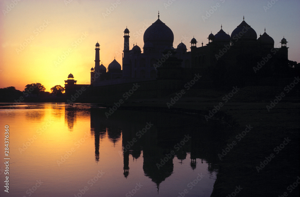 Asia, India, Agra. The sunrise silhouette of the Taj Mahal, a World Heritage Site, is reflected in the Jumna River, in Agra, India.