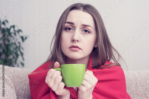 Sad woman with wild hair, she's depressed, drinks morning coffee, she can't wake up, close up, toned photo