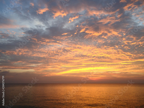 Fototapeta Naklejka Na Ścianę i Meble -   Amazing sunset on the sea in bright orange tones.