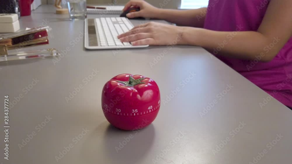 Pomodoro technique twenty five minute time productivity concept with female typing at keyboard, 4k.