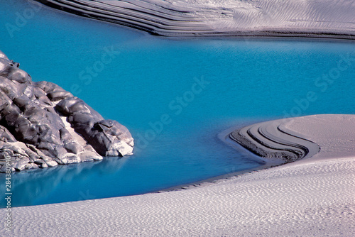 Pakistan, N-W Frontier Province, Indus River. White sand contrasts with the blue water of the Indus River near Hunza, North-West Frontier Province, Pakistan.