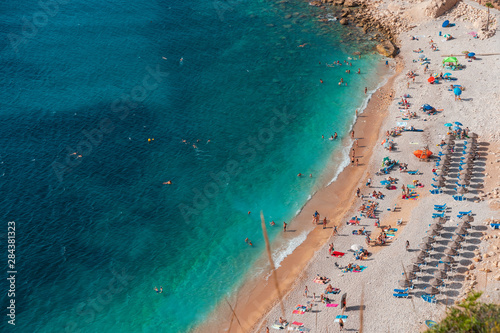 op view of people at colorful and picturesque Beach lagoon with turquoise water in Javea , Alicante, Spain. Costa Blanca.