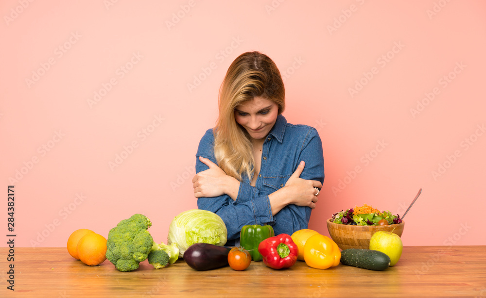 Young blonde woman with many vegetables freezing Young blonde woman with many vegetables freezing