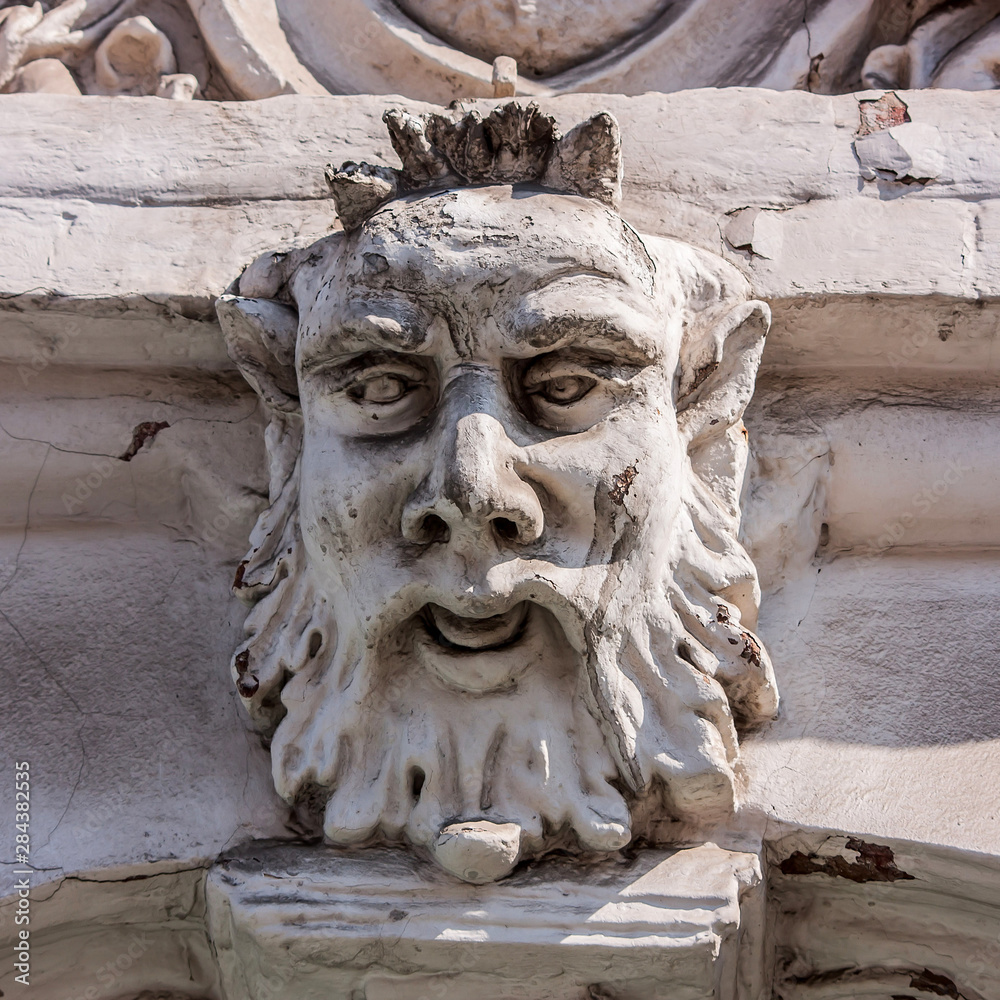 Mascaron of Satyr on building in Kyiv